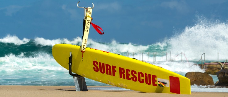 An Australian lifeguards board resting on a beach