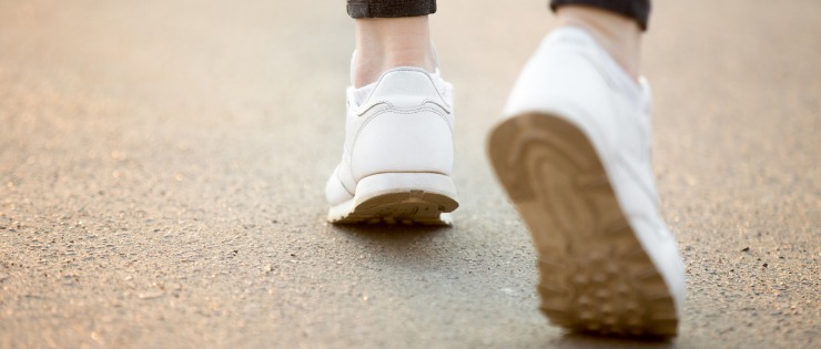 A female walking on a footpath getting her daily exercise