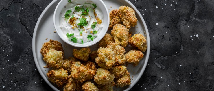 Cauliflower bites cooked in the air fryer served with sour cream 