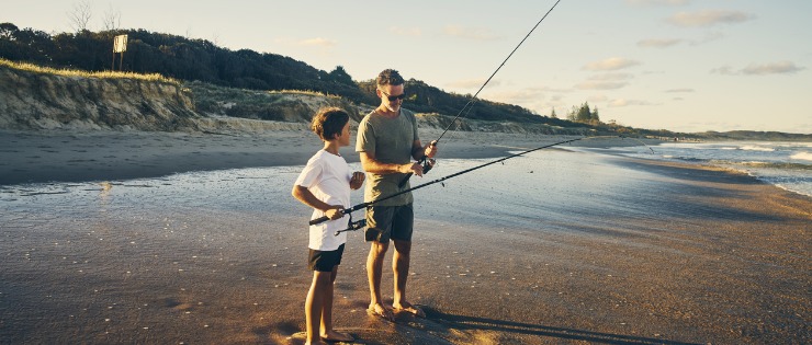 Father and son fishing off the beach in Mollymook, Sydney 