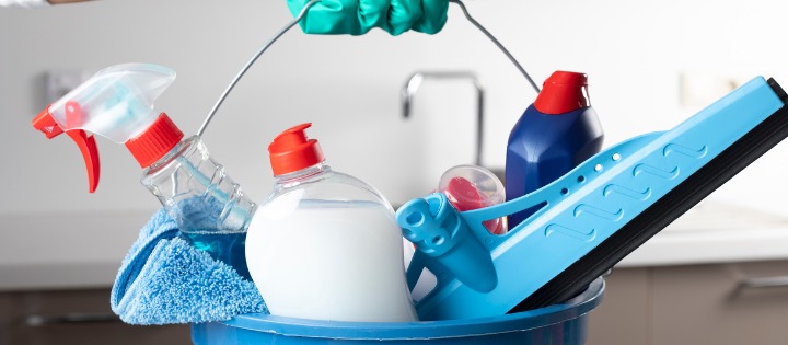 A blue bucket of cleaning products & disinfectants 