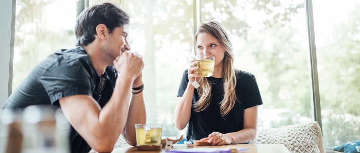 Couple sitting in a cafe sipping on green tea