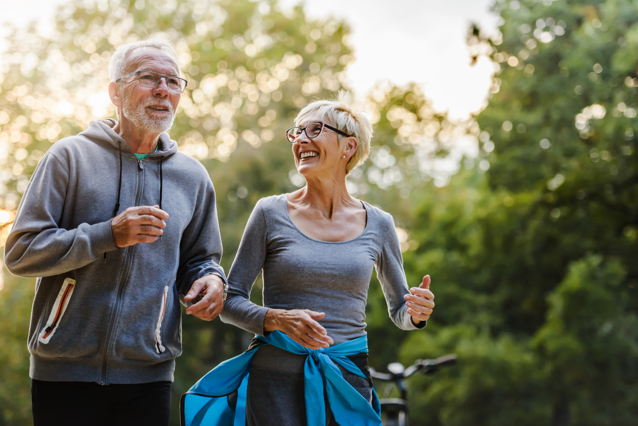 Do pensioners need private health insurance Australia | [Elderly couple walking in a park]]