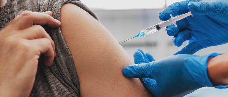 A person receiving the COVID-19 vaccination prior to travelling as a form of insurance.