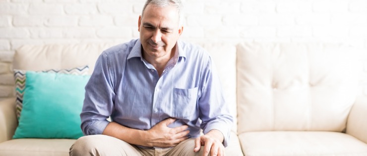 man holding his stomach because of IBS caused by amine sensitivity
