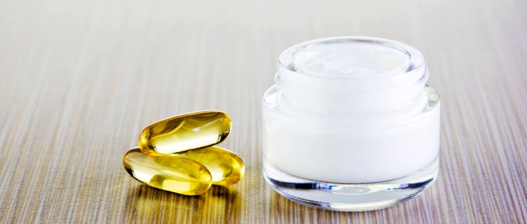 Tablet and cream collagen supplements on a white background