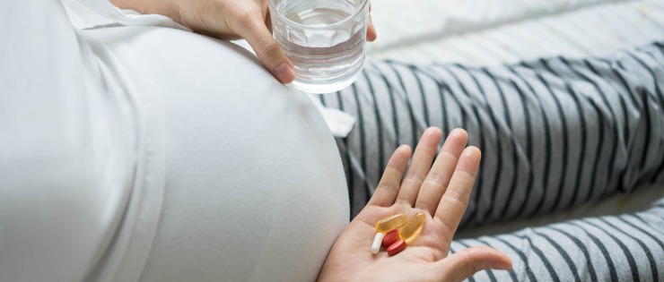 Pregnant woman taking iron supplements for her low levels of iron