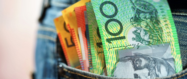 A jeans pocket full of Australian banknotes - transferring your money from Canada to Australia can be expensive