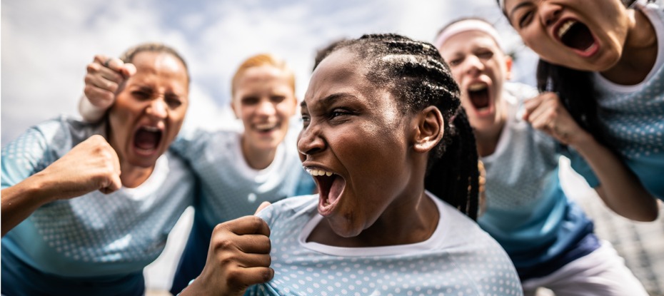 female soccer team celebrating victory