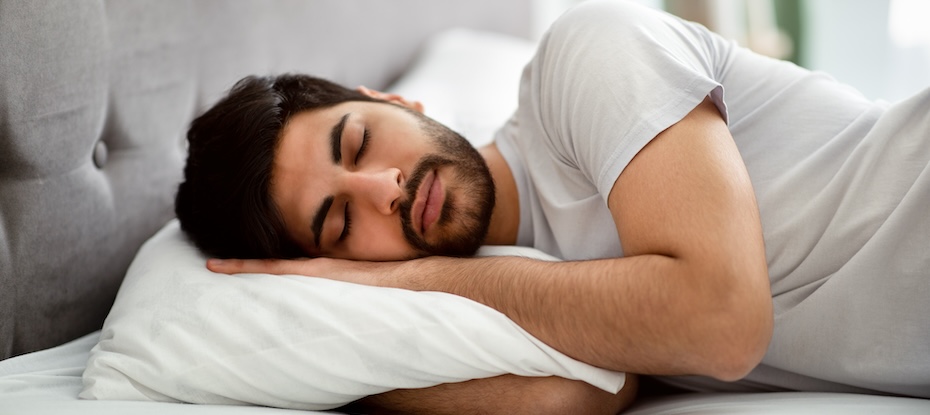Discover what REM sleep is good for as this man rests peacefully in bed.