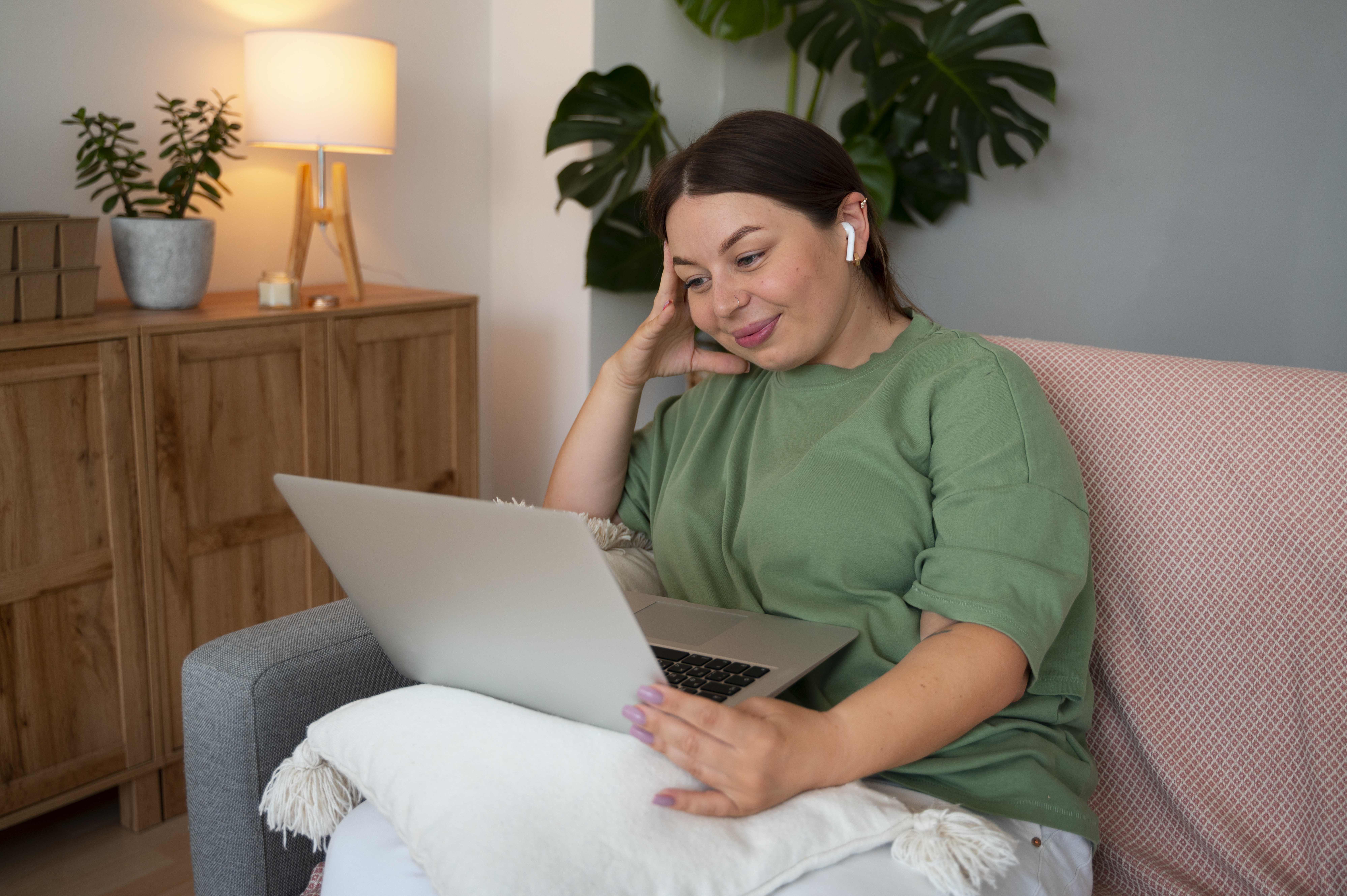 A woman in Australia speaks with her therapist via a secure video call on her laptop at home – illustrating the convenience of telehealth counselling and online therapy for mental health care.
