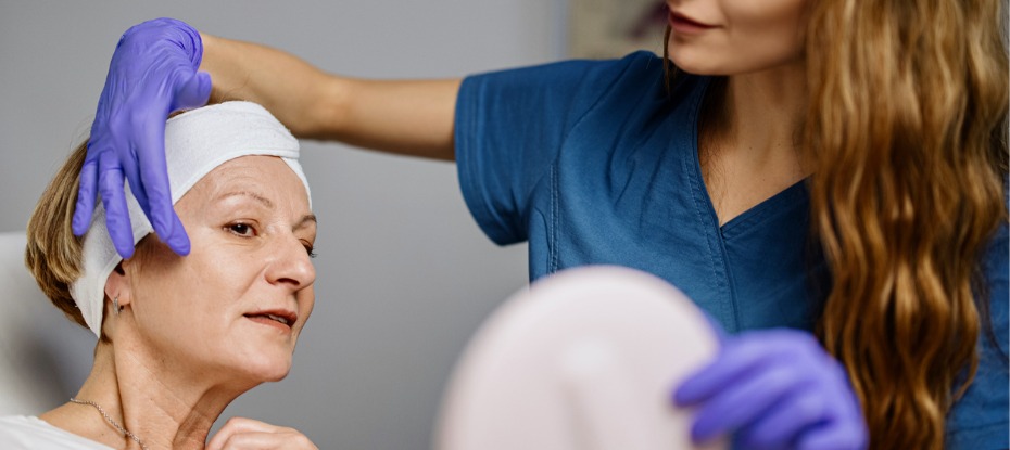 A woman is being examined by a doctor in a dermatology clinic.