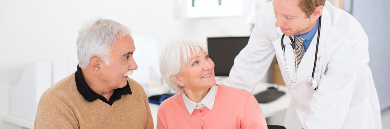 senior couple visiting male general practitioner
