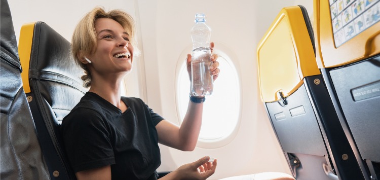 happy woman drinking water onboard 