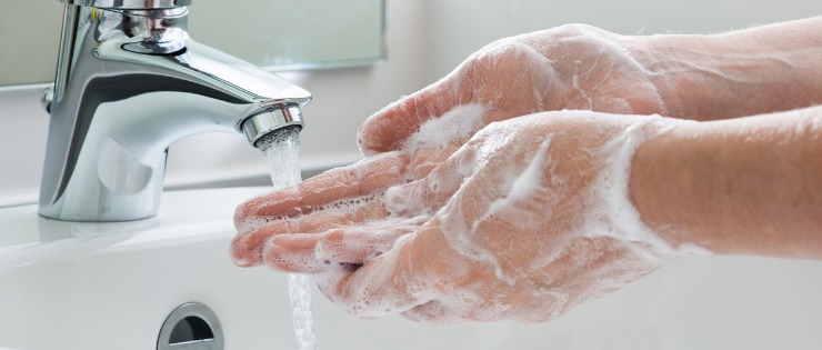 Person washing their hands before eating to avoid getting sick